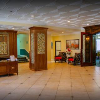 A spacious hotel lobby featuring elegant wooden decor and comfortable seating.