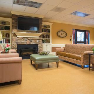 A cozy living room with a fireplace, television, and comfortable seating.