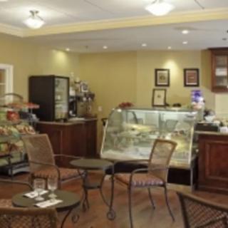 A cozy cafe interior with tables and a display counter.