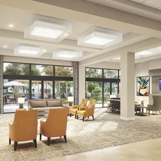 A modern lobby with comfortable seating and large windows allowing natural light.