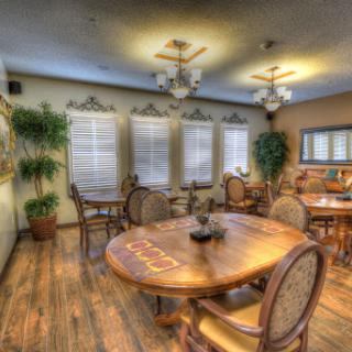 A cozy dining room featuring elegant wooden furniture and warm lighting.
