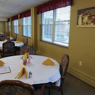A well-set dining area featuring elegantly arranged tables ready for guests.