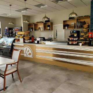 A cozy and modern cafe interior featuring a well-organized counter and seating area.