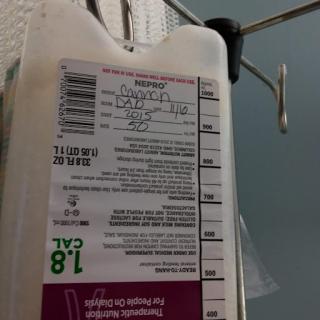 An IV bag hanging with a detailed label for medical use.