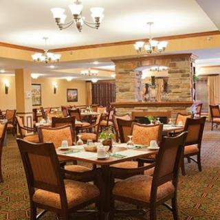 A cozy restaurant interior featuring well-arranged tables and warm lighting.