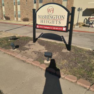 Entrance sign for Washington Heights apartment complex.