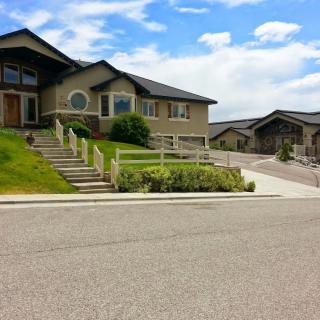 A suburban residential house with a well-maintained yard and driveway on a quiet street.