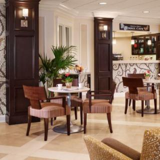 A cozy, well-decorated cafe interior with seating and a bar area.