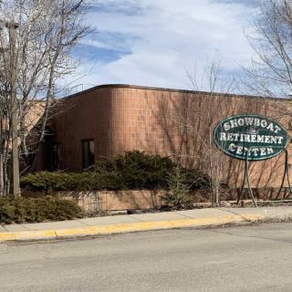 Exterior view of Concordia Retirement Center with surrounding trees and road.
