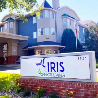 Exterior view of Iris Senior Living with a prominent sign in the foreground.