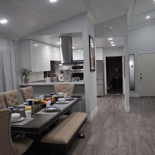Modern open-concept kitchen and dining area with elegant table setting.