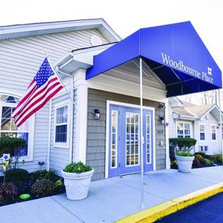 Entrance of a building with an awning and American flag.