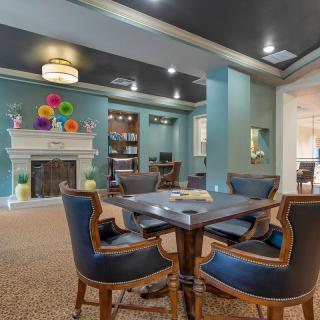 A modern living area with a cozy seating arrangement and a colorful fireplace.
