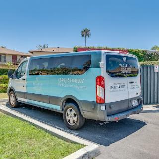 A parked van in a sunny outdoor setting.