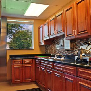 A cozy kitchen with wooden cabinets and a window view.