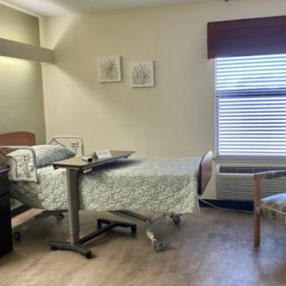 A hospital room with a bed, medical equipment, and a window.