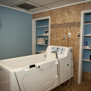 A serene spa-like bathroom featuring a modern tub and organized shelves.