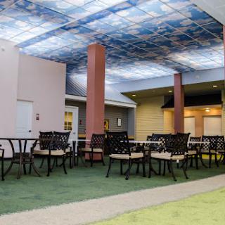 A modern indoor lounge area featuring comfortable seating and a creatively designed ceiling.
