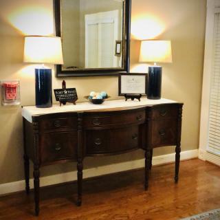 A stylish console table with a mirror and lamps, enhancing the interior decor.