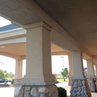 View of architectural pillars supporting a building's overhang.