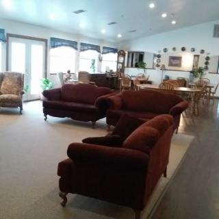 A spacious living room with plush sofas and wood flooring.