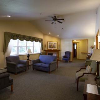 A cozy living room with comfortable seating and natural light from a large window.