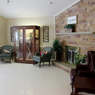 A cozy living room featuring a fireplace, comfortable seating, and decorative elements.