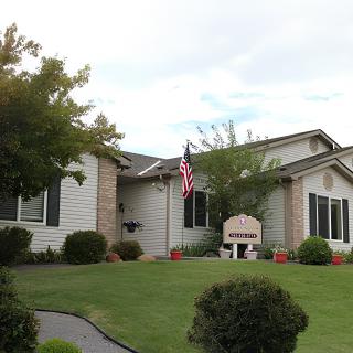 A suburban house with a well-maintained lawn and an American flag.