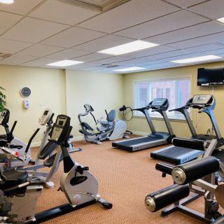 A well-equipped gym with treadmills, exercise bikes, and other fitness equipment.