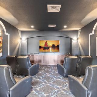 A modern home theater with comfortable seating and a large screen.