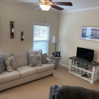 A cozy living room with a sofa, coffee table, and television.