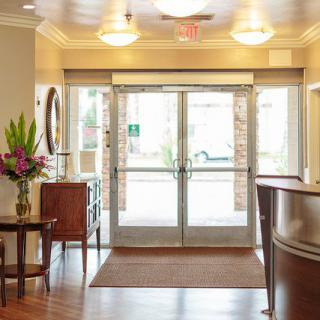 A well-decorated lobby with modern furnishings and a glass entrance.