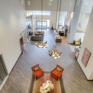 A spacious and modern living room with elegant lighting and stylish furniture.