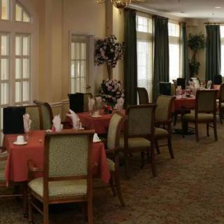 A beautifully set dining room with tables and chairs, featuring elegant decor.