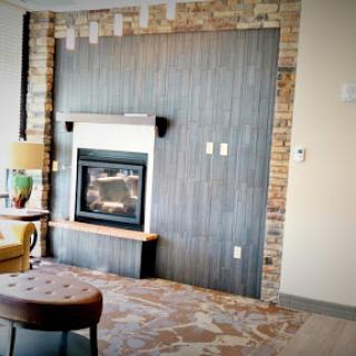 A cozy living room featuring a stylish fireplace and modern decor.