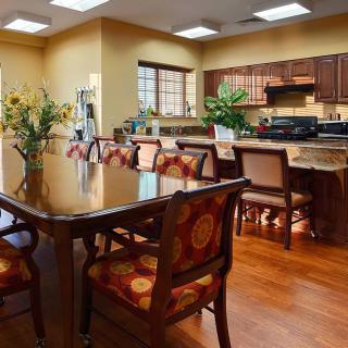 A spacious kitchen and dining area with elegant wooden furniture and warm decor.