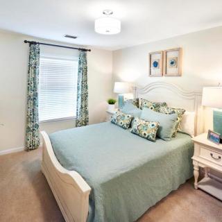 A cozy and elegantly decorated bedroom with soft lighting and coordinated decor.