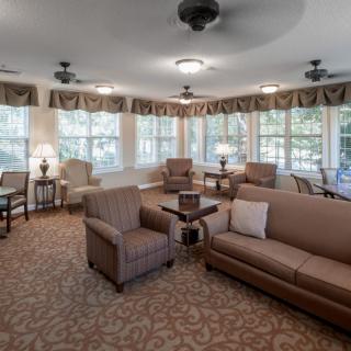 A cozy living room with comfortable seating and large windows letting in natural light.