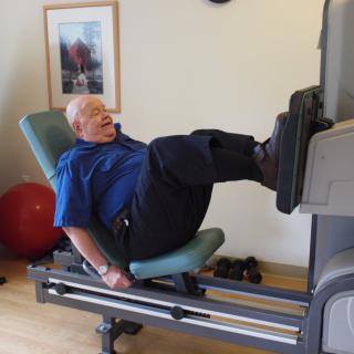 A person using a leg press machine in a gym setting.