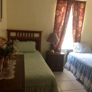 A cozy bedroom with two single beds and a warm atmosphere.