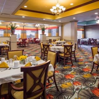 An elegant restaurant dining room with beautifully set tables and vibrant decor.