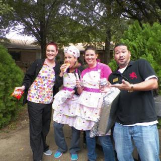 A cheerful group of friends dressed in funny costumes, enjoying a day outdoors.