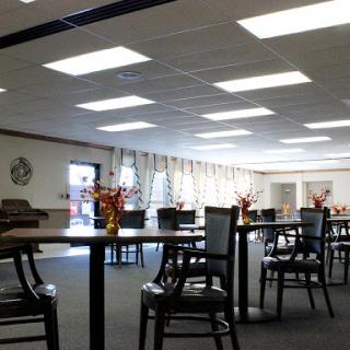 A spacious and well-lit dining room featuring tables arranged for a comfortable gathering.
