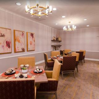 Elegant dining room with stylish furniture and warm lighting.