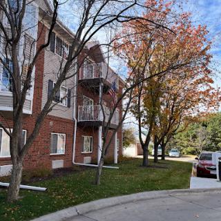 A cozy apartment building surrounded by autumn trees.