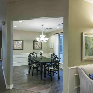 A cozy dining room featuring elegant furniture and ambient lighting.