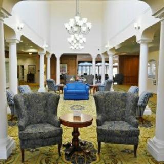 Elegant lobby interior with classic furniture and chandeliers.