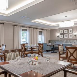 A modern dining room with neatly arranged tables and chairs.