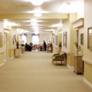 A well-lit hallway with seating and decor.