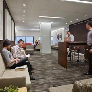 A modern office lobby with people working and waiting.